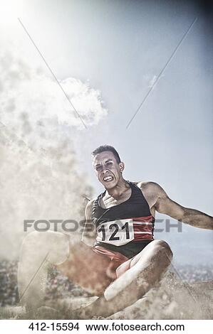 Long jumper landing in sand View Large Photo Image Picture - Long jumper landing in sand. Fotosearch