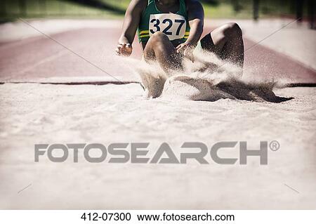 Long jumper landing in sand View Large Photo Image Stock Image - Long jumper landing in sand. Fotosearch