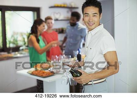 Man carrying bottle of wine at party View Large Photo Image Stock Photograph - Man carrying bottle of wine at party. Fotosearch