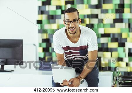 Man holding digital tablet in office View Large Photo Image Stock Photography - Man holding digital tablet in office. Fotosearch