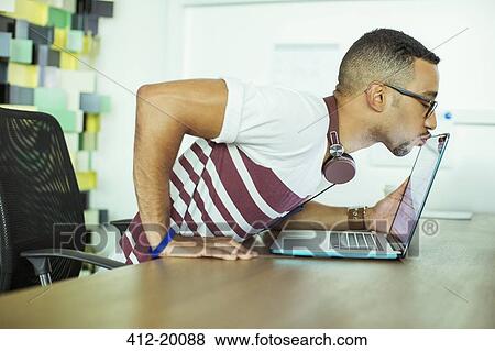 Man kissing laptop in office View Large Photo Image Stock Photo - Man kissing laptop in office. Fotosearch