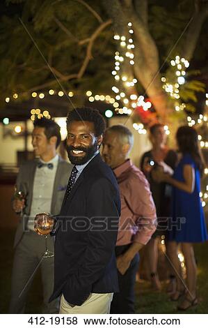 Man laughing at party View Large Photo Image Stock Photo - Man laughing at party. Fotosearch