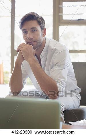 Man resting chin in hands View Large Photo Image Stock Image - Man resting chin in hands. Fotosearch