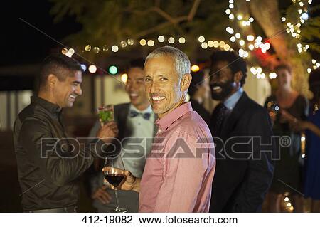 Man smiling at party View Large Photo Image Stock Image - Man smiling at party. Fotosearch