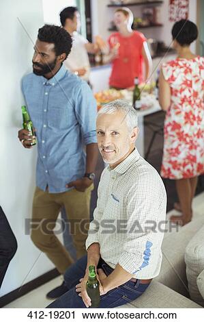 Man smiling at party View Large Photo Image Stock Image - Man smiling at party. Fotosearch