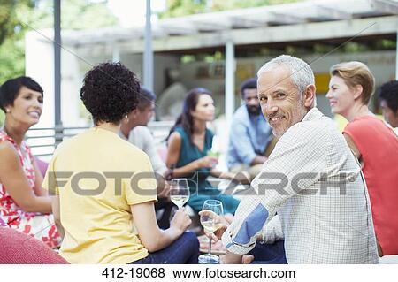 Man smiling at party View Large Photo Image Stock Photo - Man smiling at party. Fotosearch