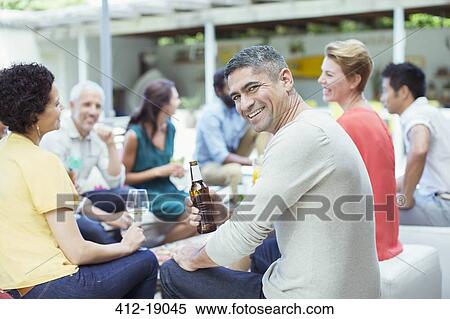 Man smiling at party View Large Photo Image Stock Photography - Man smiling at party. Fotosearch