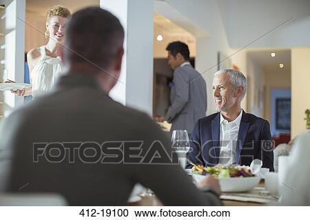 Man smiling at table at dinner party View Large Photo Image Stock Image - Man smiling at table at dinner party. Fotosearch