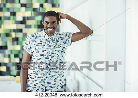 Stock Photo - Man smiling in office. Fotosearch
