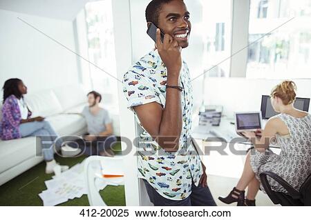 Man talking on cell phone in office View Large Photo Image Stock Photography - Man talking on cell phone in office. Fotosearch