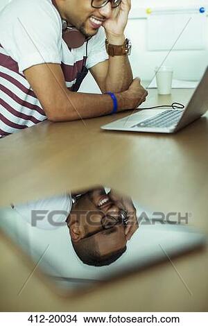 Man's face reflected in digital tablet View Large Photo Image Picture - Man's face reflected in digital tablet. Fotosearch