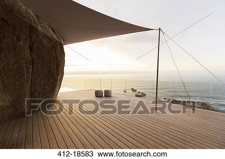Stock Image - Modern balcony overlooking ocean. Fotosearch