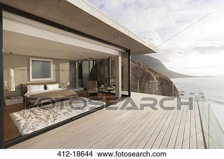 Modern bedroom opening onto balcony View Large Photo Image Picture - Modern bedroom opening onto balcony. Fotosearch