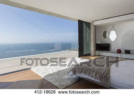Modern bedroom overlooking ocean View Large Photo Image Stock Photo - Modern bedroom overlooking ocean. Fotosearch