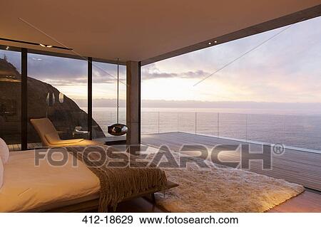 Stock Photo - Modern bedroom overlooking ocean. Fotosearch
