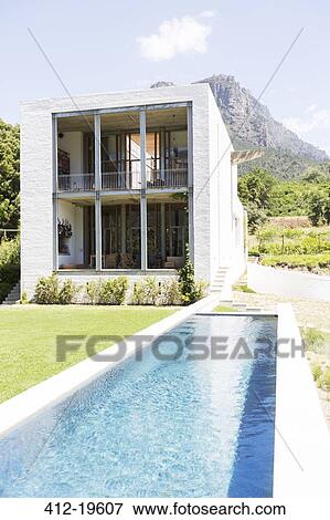 Stock Photo - Modern house with swimming pool in rural landscape. Fotosearch