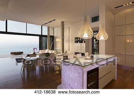 Stock Photo - Modern kitchen and living area overlooking ocean. Fotosearch