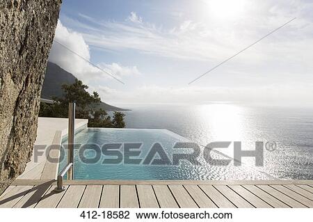 Modern swimming pool overlooking ocean View Large Photo Image Stock Image - Modern swimming pool overlooking ocean. Fotosearch