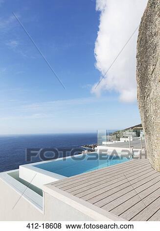 Modern swimming pool overlooking ocean View Large Photo Image Stock Photo - Modern swimming pool overlooking ocean. Fotosearch