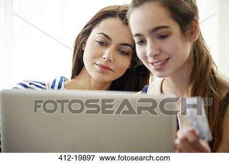 Mother and daughter shopping online View Large Photo Image Stock Photo - Mother and daughter shopping online. Fotosearch