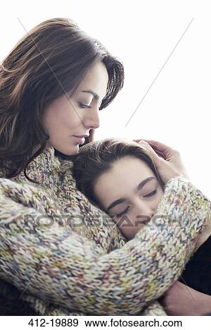 Mother hugging daughter View Large Photo Image Stock Photo - Mother hugging daughter. Fotosearch