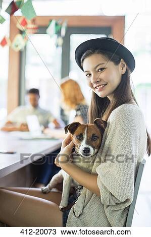 People holding dog at conference table in office View Large Photo Image Stock Image - People holding dog at conference table in office. Fotosearch