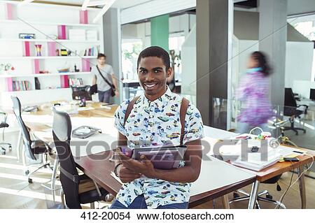 Picture - People smiling at conference table in office. Fotosearch
