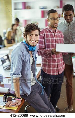 People smiling in office View Large Photo Image Stock Photo - People smiling in office. Fotosearch