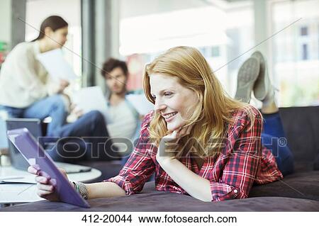 People using digital tablet in office View Large Photo Image Picture - People using digital tablet in office. Fotosearch