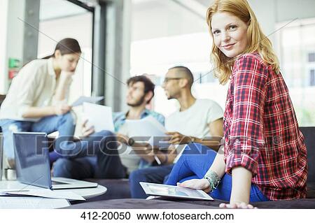 Stock Image - People using digital tablet in office. Fotosearch