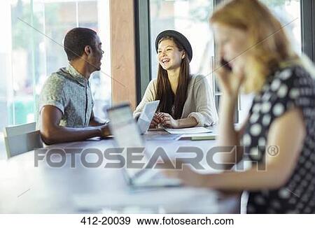 People working at conference table in office View Large Photo Image Stock Photo - People working at conference table in office. Fotosearch