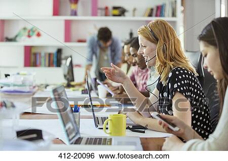 People working at conference table in office View Large Photo Image Stock Photograph - People working at conference table in office. Fotosearch