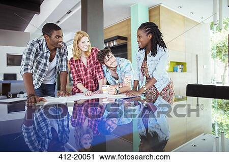 People working together at conference table in office View Large Photo Image Stock Image - People working together at conference table in office. Fotosearch