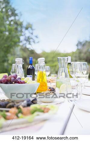 Plates of food on table outdoors View Large Photo Image Picture - Plates of food on table outdoors. Fotosearch