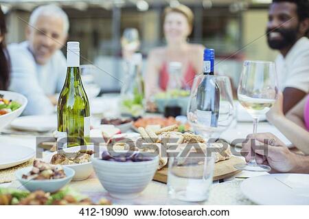 Stock Image - Plates of food on table outdoors. Fotosearch