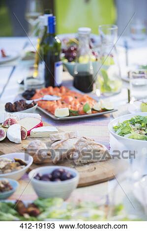 Plates of food on table outdoors View Large Photo Image Stock Image - Plates of food on table outdoors. Fotosearch