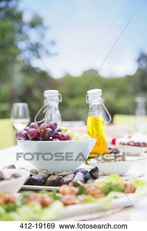 Plates of food on table outdoors View Large Photo Image Stock Photo - Plates of food on table outdoors. Fotosearch