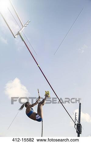 Stock Image - Pole jumper approaching bar. Fotosearch
