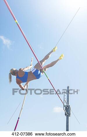 Stock Photograph - Pole jumper clearing bar. Fotosearch