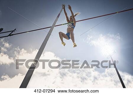 Pole vaulter clearing bar View Large Photo Image Picture - Pole vaulter clearing bar. Fotosearch