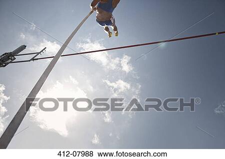 Pole vaulter clearing bar View Large Photo Image Stock Photo - Pole vaulter clearing bar. Fotosearch