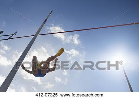 Pole vaulter clearing bar View Large Photo Image Stock Photography - Pole vaulter clearing bar. Fotosearch