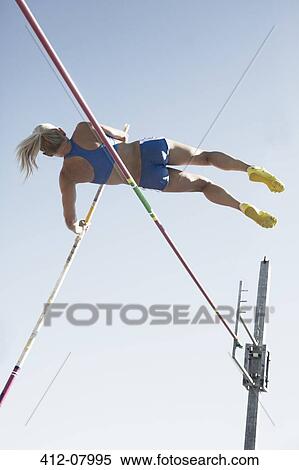 Pole vaulter clearing bar View Large Photo Image Stock Photography - Pole vaulter clearing bar. Fotosearch