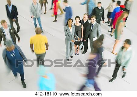 Portrait of business people among bustling crowd View Large Photo Image Stock Image - Portrait of business people among bustling crowd. Fotosearch