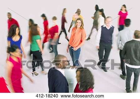 Stock Image - Portrait of businesswoman standing out from the crowd. Fotosearch