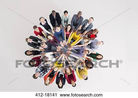 Stock Image - Portrait of confident business people in huddle. Fotosearch