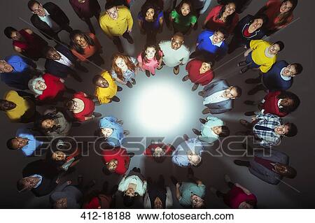 Portrait of confident business people around bright light View Large Photo Image Stock Photo - Portrait of confident business people around bright light. Fotosearch