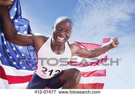 Portrait of enthusiastic track and field athlete holding American flag View Large Photo Image Stock Photo - Portrait of enthusiastic track and field athlete holding American flag. Fotosearch