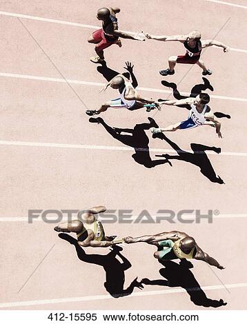 Relay runners handing off batons on track View Large Photo Image Stock Photography - Relay runners handing off batons on track. Fotosearch