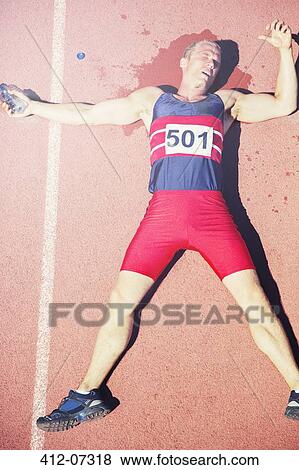 Runner laying on track View Large Photo Image Stock Photo - Runner laying on track. Fotosearch